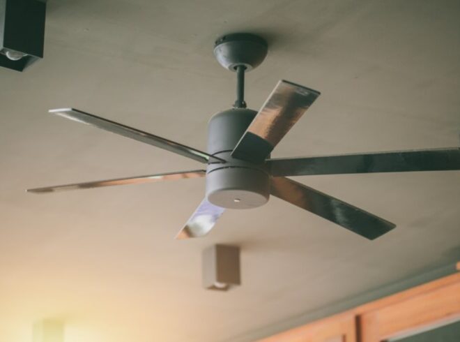 Ceiling fan with metallic blades and modern design, featured in a home setting, relevant to tips on ceiling fan noise in Manhattan Beach homes.