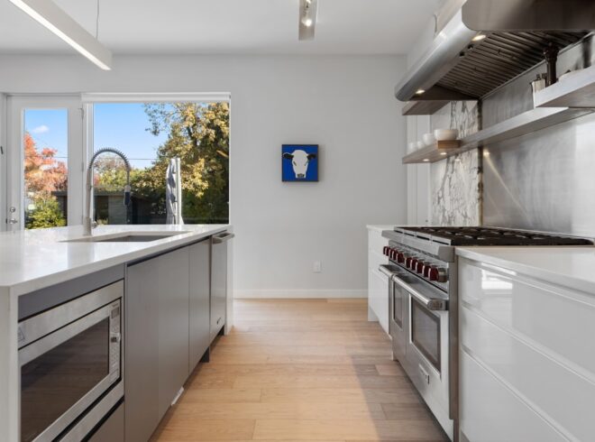 Modern kitchen with updated electrical panel and stainless steel appliances for home safety.