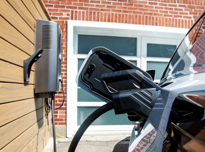 ev charger plugged into a modern home garage wall unit